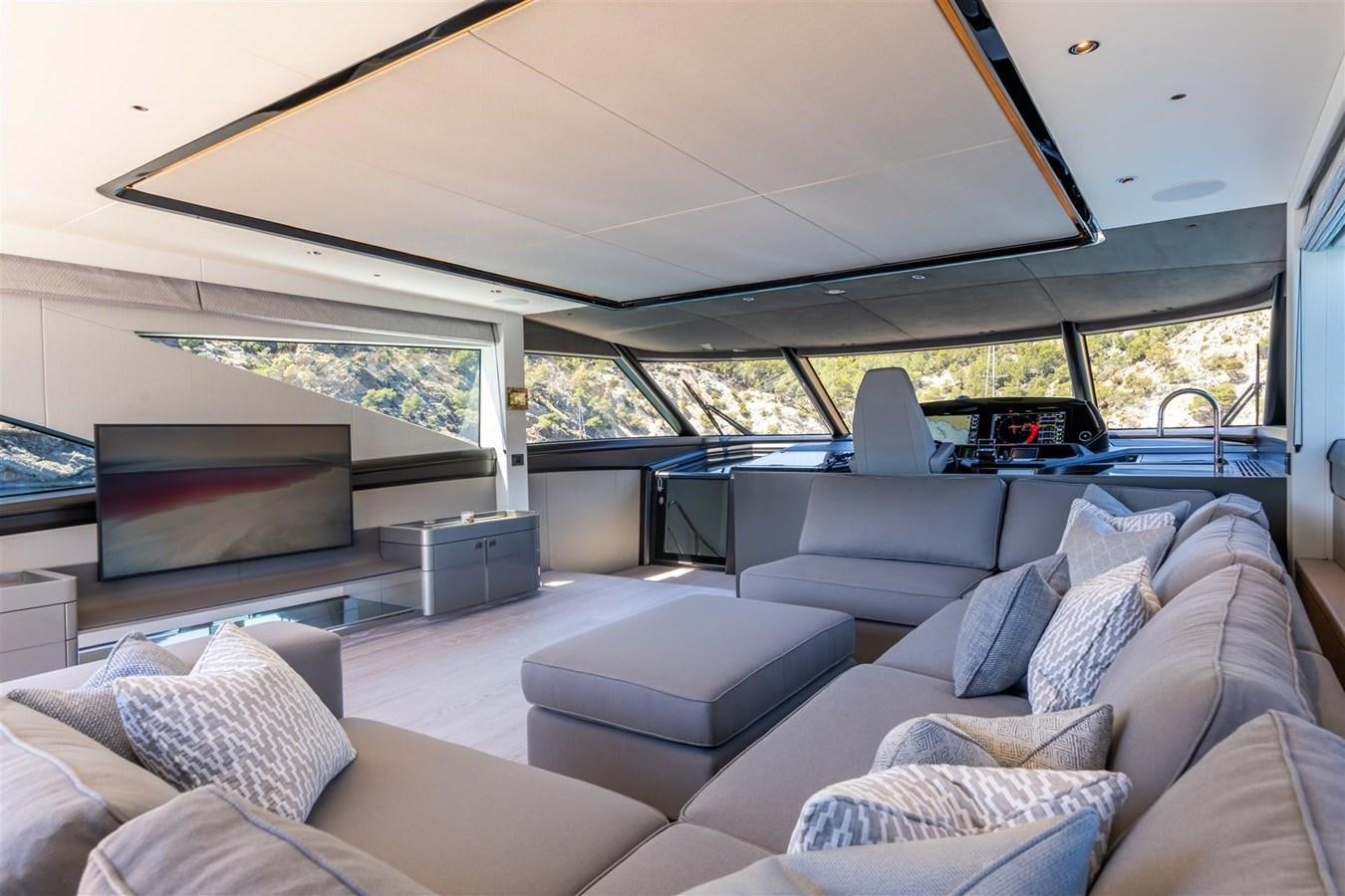 a living room with a large window aboard OCEAN 182 Yacht for Sale