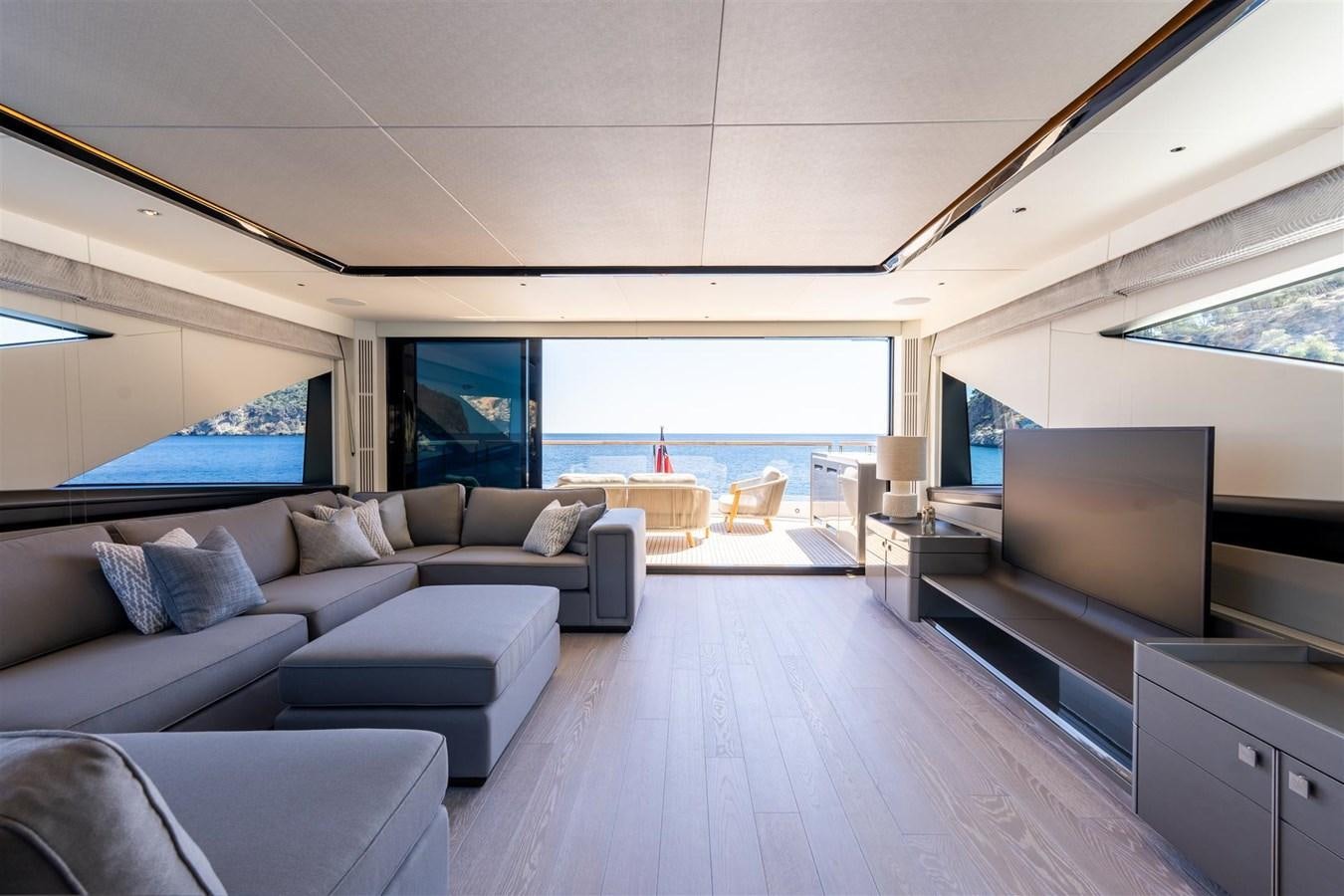 a living room with a large window aboard OCEAN 182 Yacht for Sale