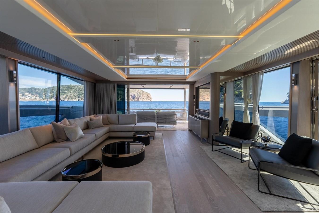 a living room with a large window aboard OCEAN 182 Yacht for Sale