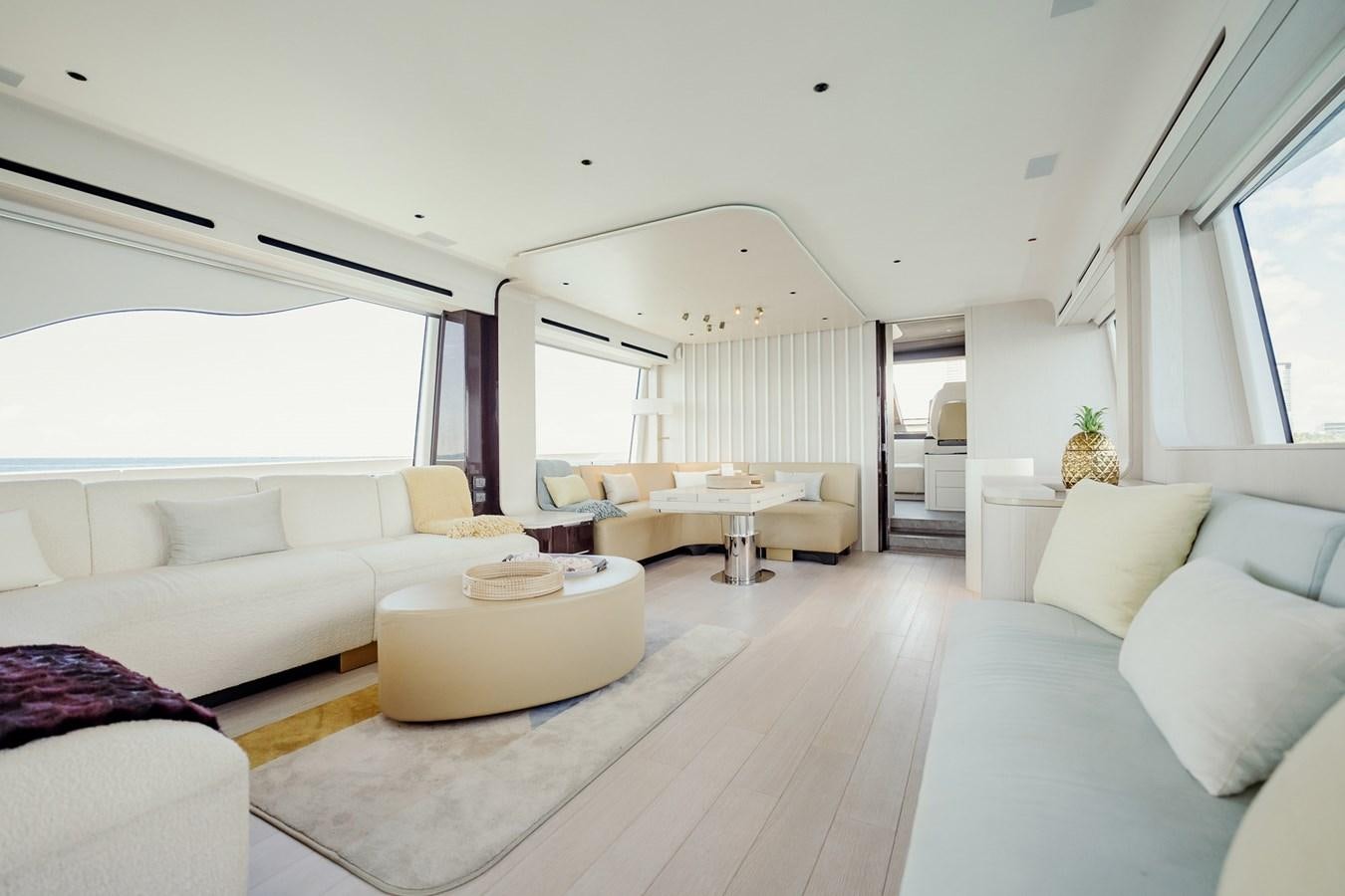 a living room with white couches aboard TRANSCENDENCE Yacht for Sale
