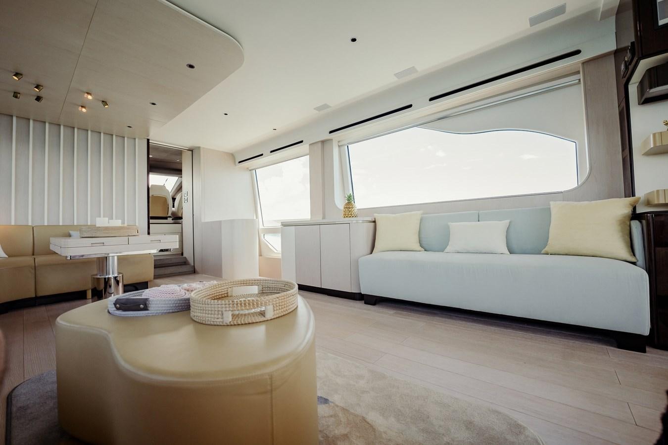 a living room with a couch and a table aboard TRANSCENDENCE Yacht for Sale
