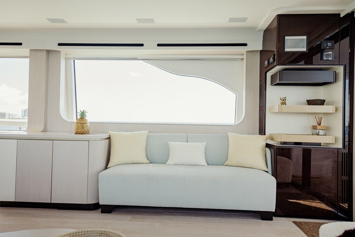 a white couch in a room aboard TRANSCENDENCE Yacht for Sale