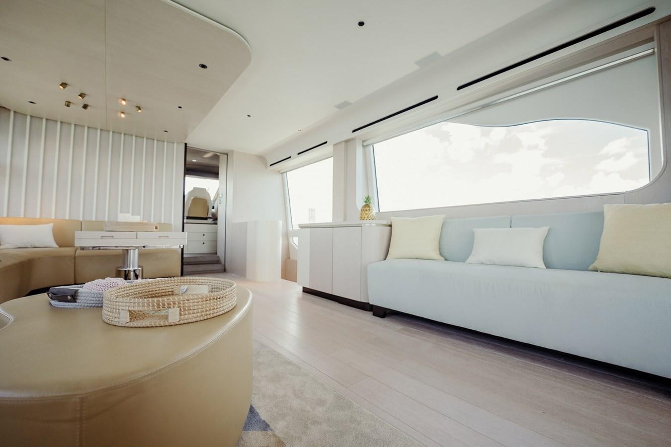 a living room with a couch and a table aboard TRANSCENDENCE Yacht for Sale