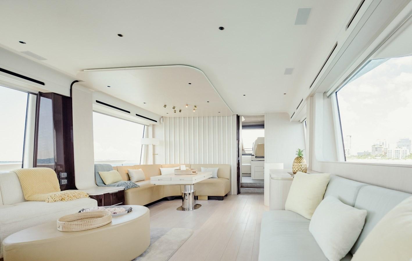 a living room with white couches aboard TRANSCENDENCE Yacht for Sale