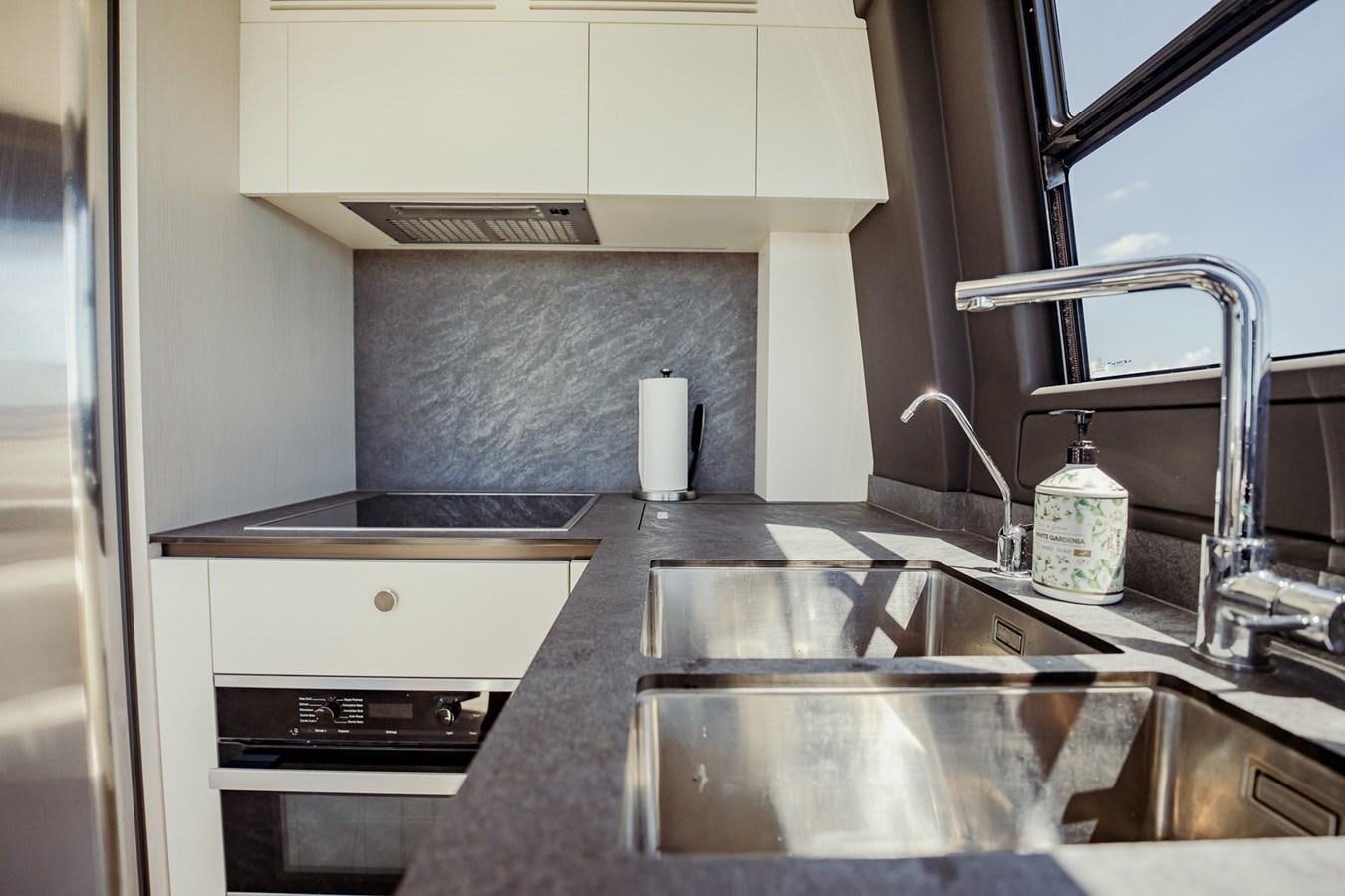 a kitchen with a sink and a faucet aboard TRANSCENDENCE Yacht for Sale