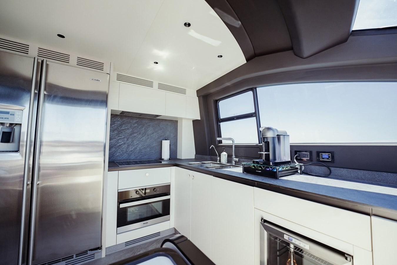 a kitchen with white cabinets aboard TRANSCENDENCE Yacht for Sale