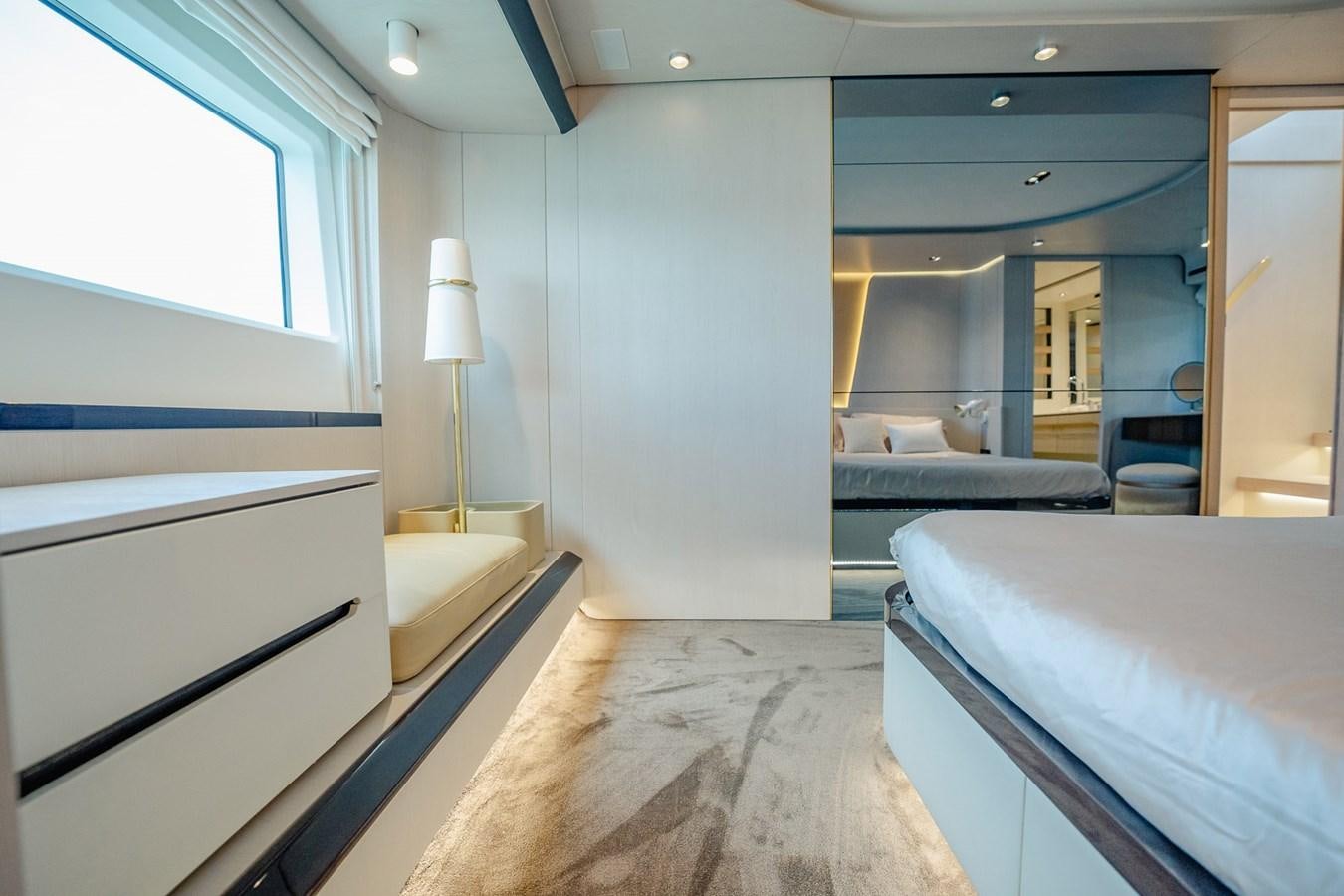 a room with a bed and a desk aboard TRANSCENDENCE Yacht for Sale
