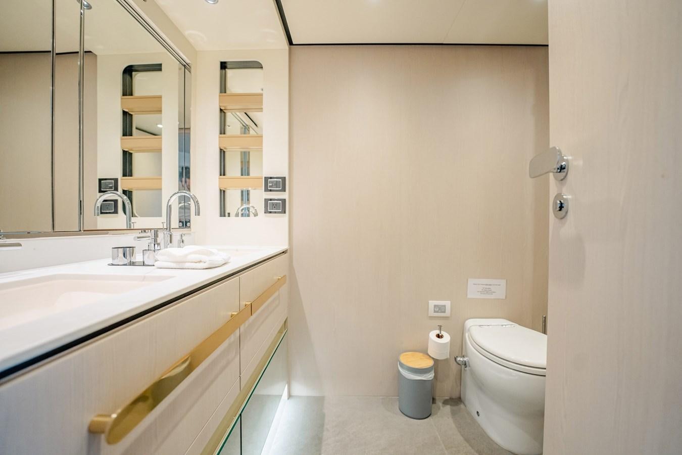 a bathroom with a sink toilet and a mirror aboard TRANSCENDENCE Yacht for Sale