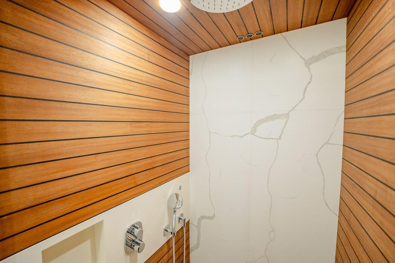 a white fan on a wooden wall aboard TRANSCENDENCE Yacht for Sale