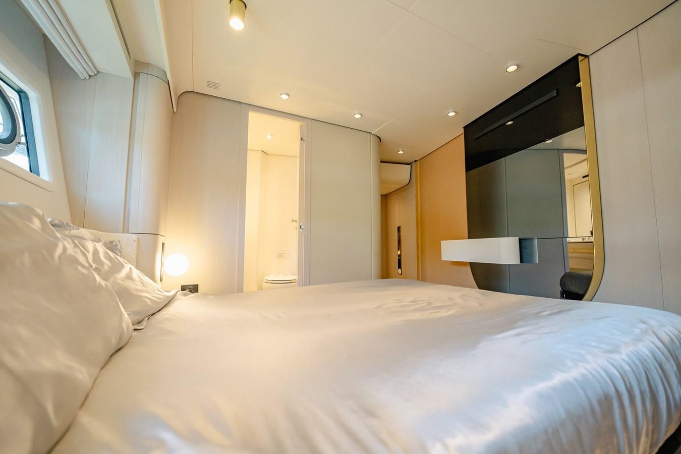 a bed with white sheets aboard TRANSCENDENCE Yacht for Sale