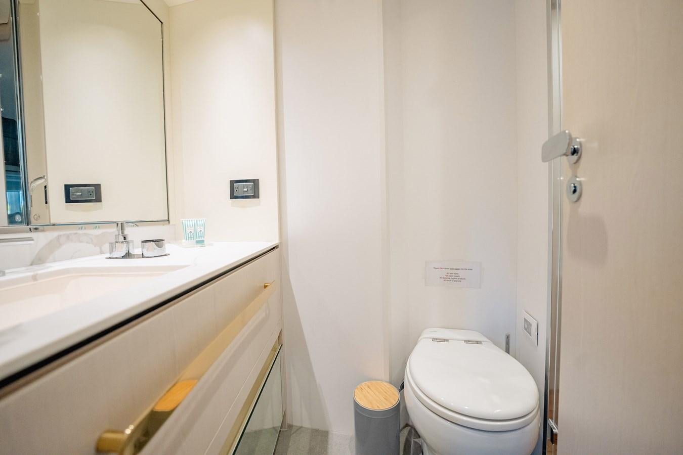 a bathroom with a toilet and sink aboard TRANSCENDENCE Yacht for Sale