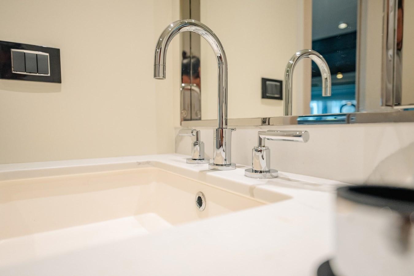 a bathroom sink with a large mirror aboard TRANSCENDENCE Yacht for Sale