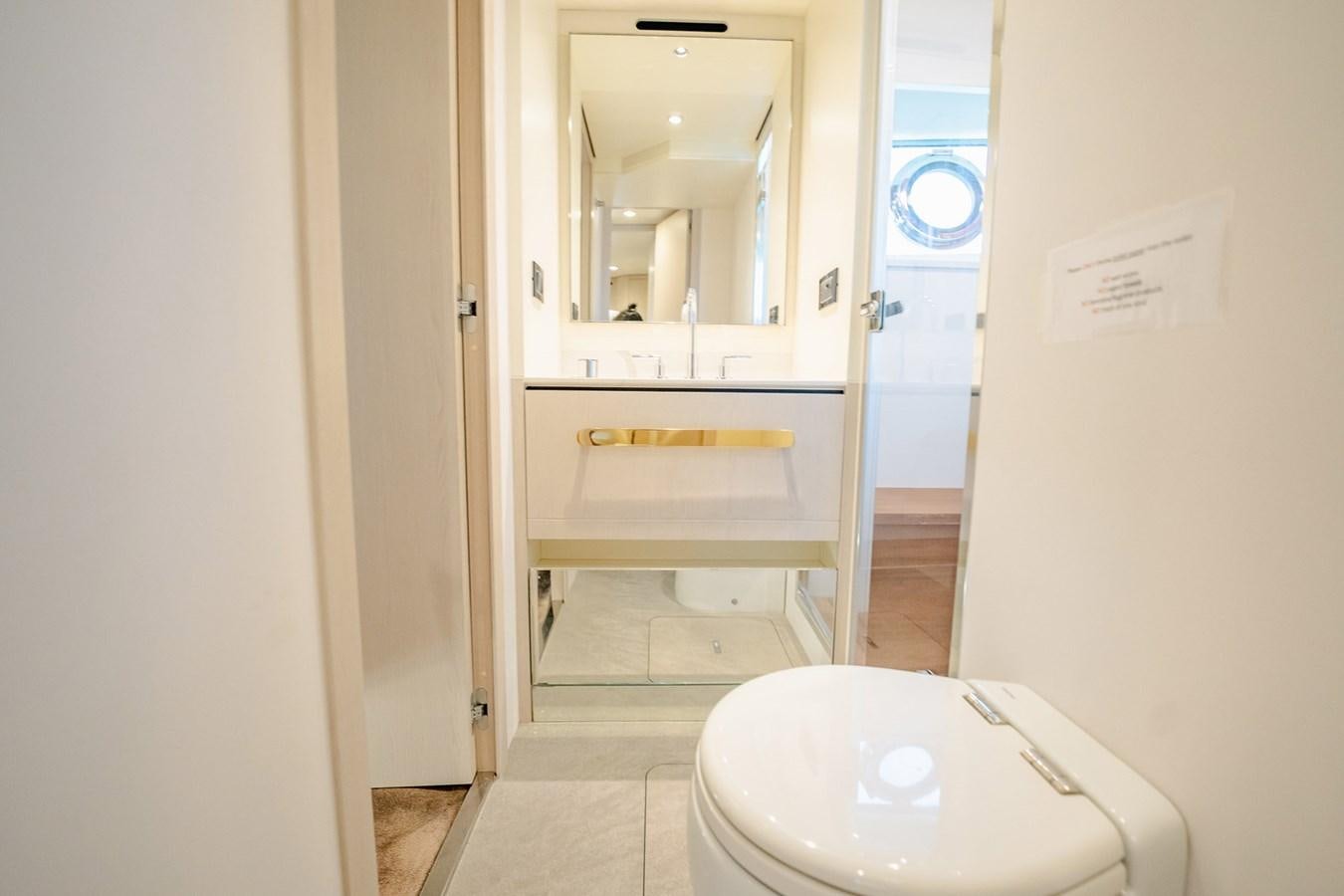 a bathroom with a toilet and a sink aboard TRANSCENDENCE Yacht for Sale