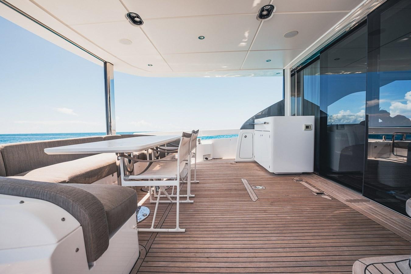 a room with a table and chairs aboard TRANSCENDENCE Yacht for Sale