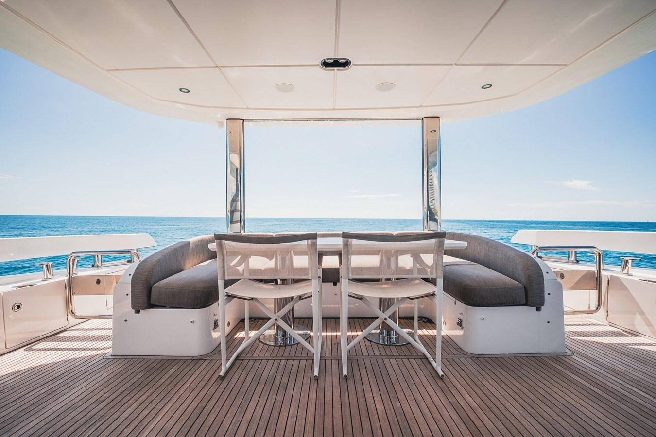 a room with a table and chairs aboard TRANSCENDENCE Yacht for Sale