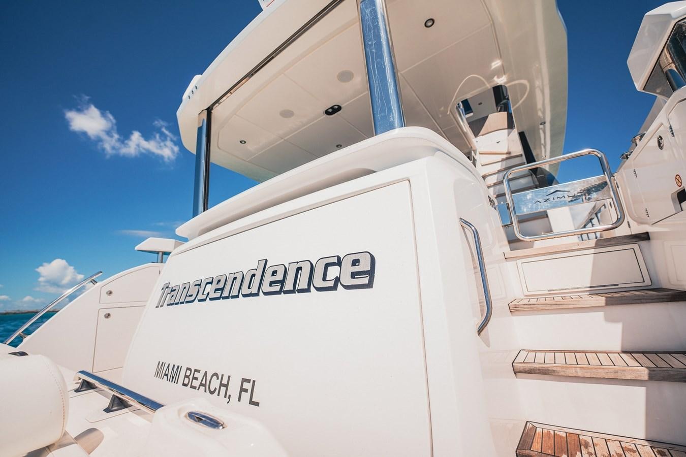 a white boat with a sign on it aboard TRANSCENDENCE Yacht for Sale