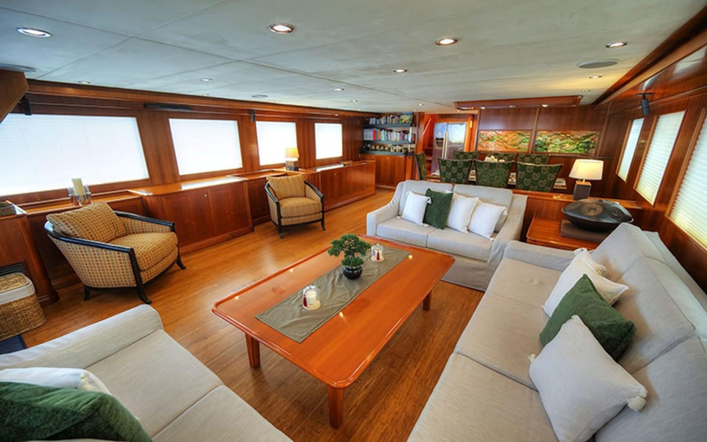 a living room with a table and chairs aboard VOYAGER Yacht for Sale