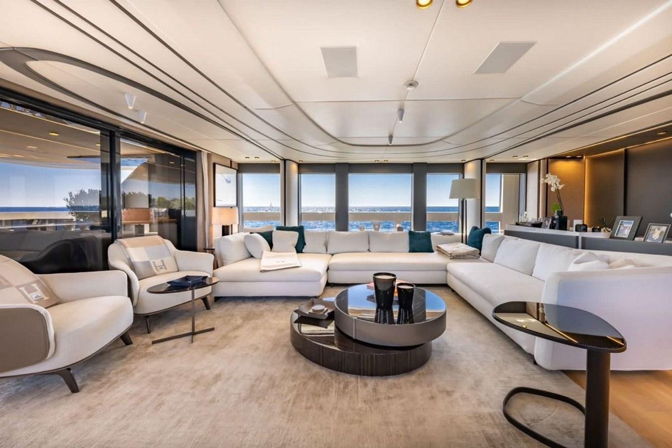 a room with couches and a table aboard MY UILIA Yacht for Sale