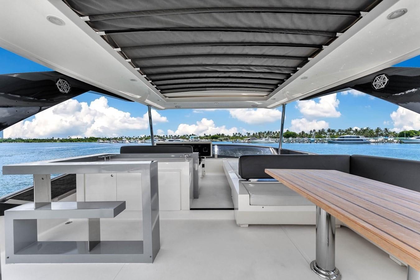 a deck with a table and chairs aboard GREYT ESCAPE Yacht for Sale
