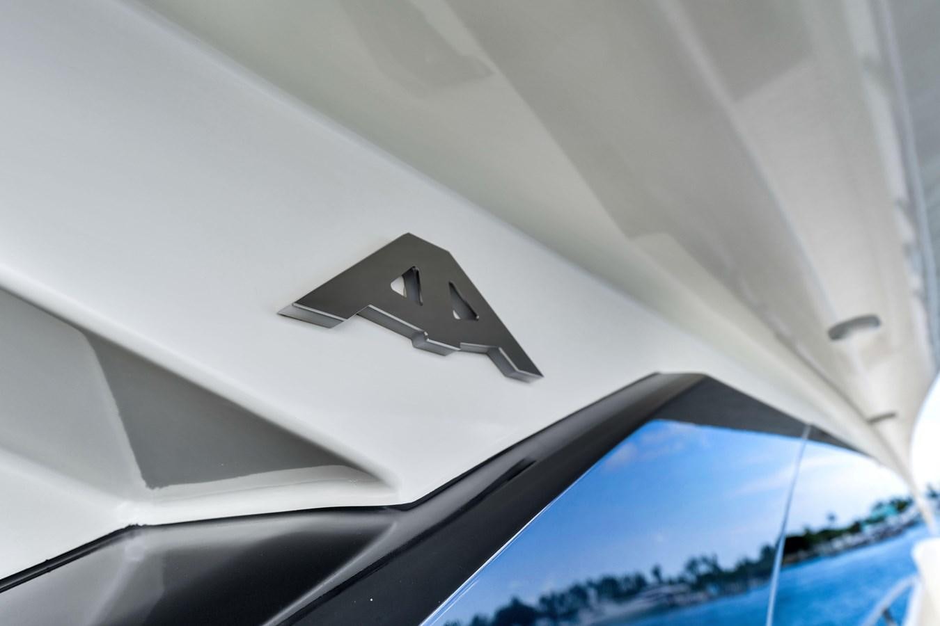 a white car with a black logo aboard GREYT ESCAPE Yacht for Sale