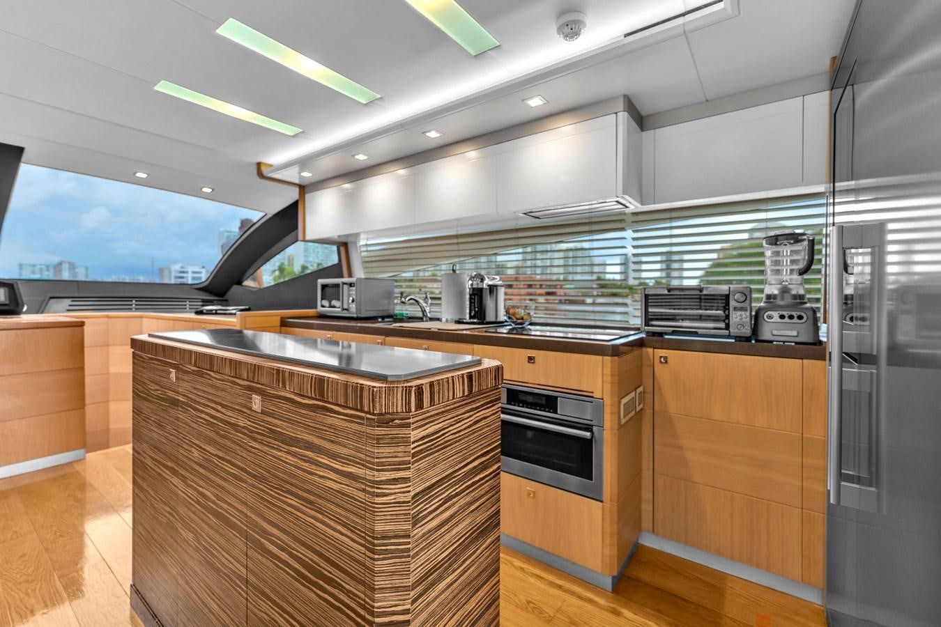 a kitchen with a large window aboard GREYT ESCAPE Yacht for Sale