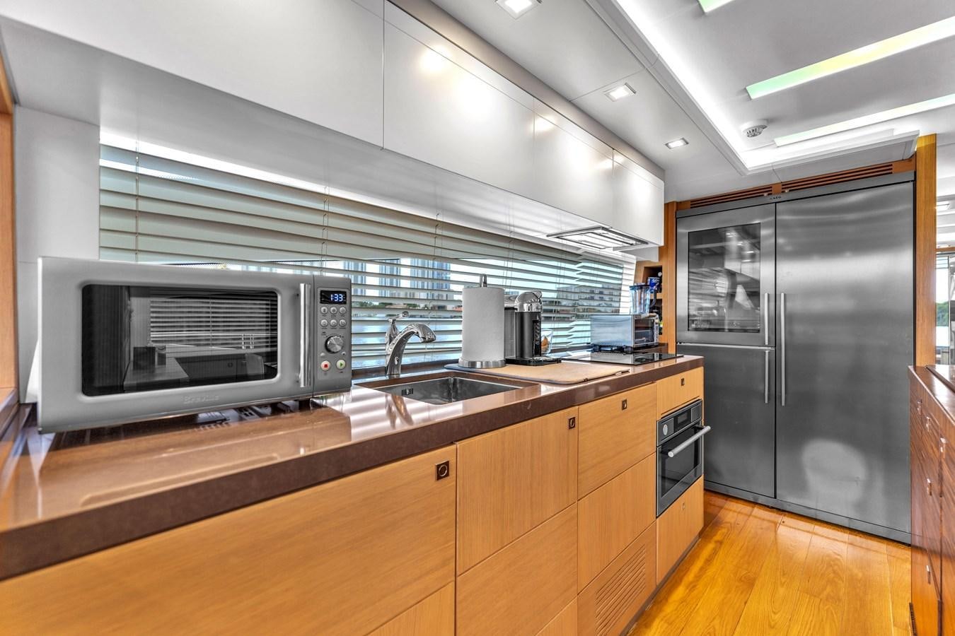 a kitchen with a microwave oven aboard GREYT ESCAPE Yacht for Sale