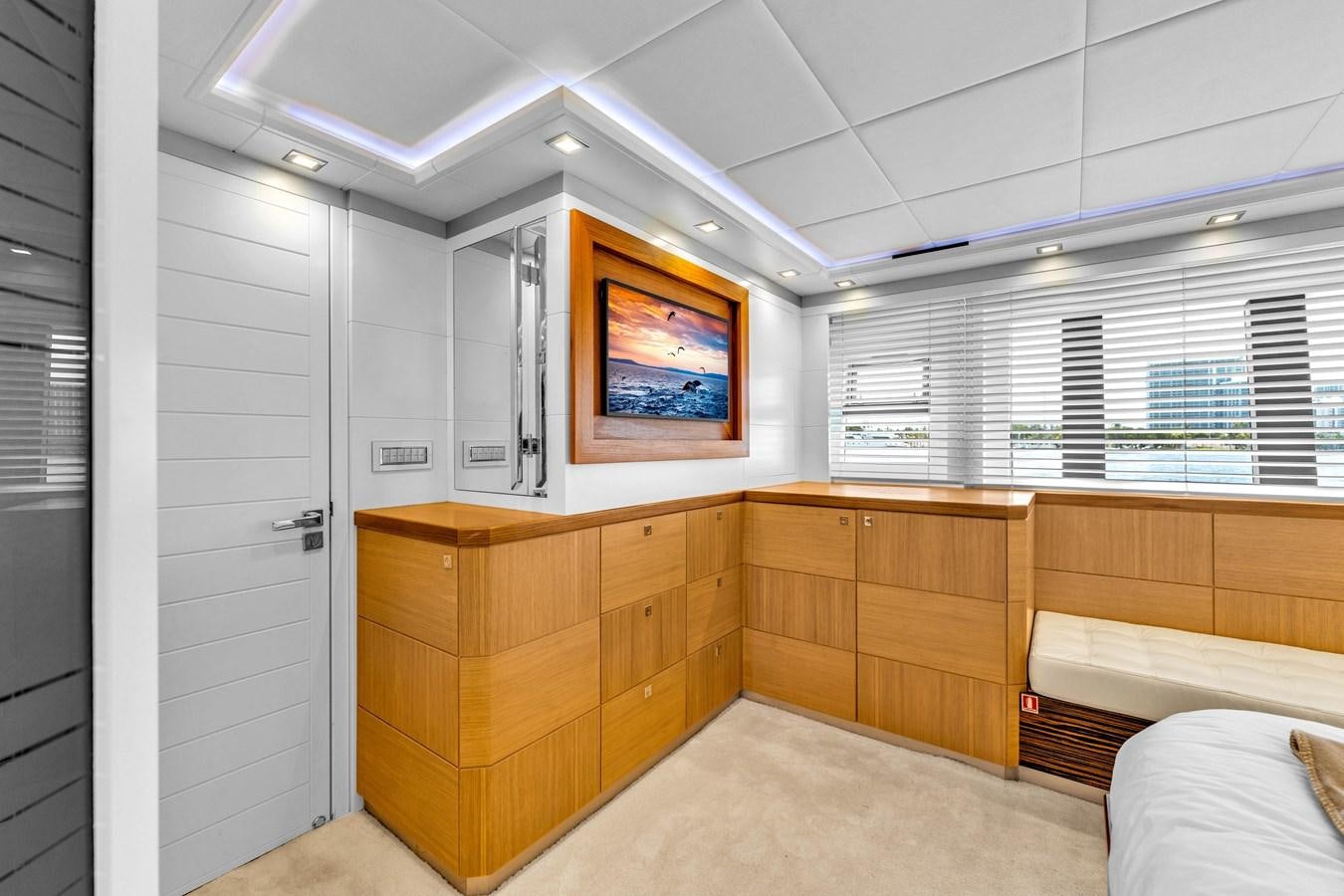 a room with a tv and cabinets aboard GREYT ESCAPE Yacht for Sale