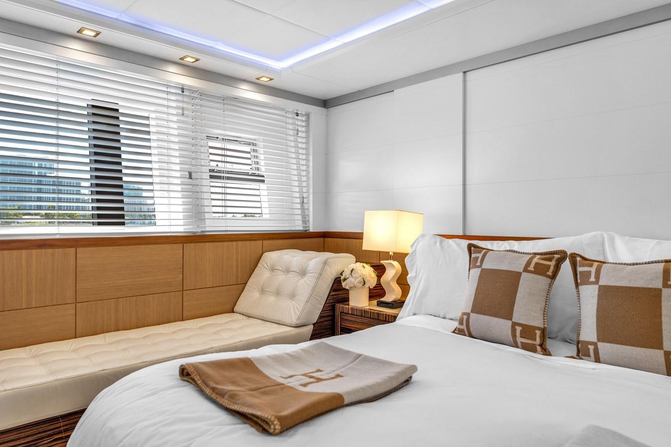 a bed with a white comforter and pillows aboard GREYT ESCAPE Yacht for Sale