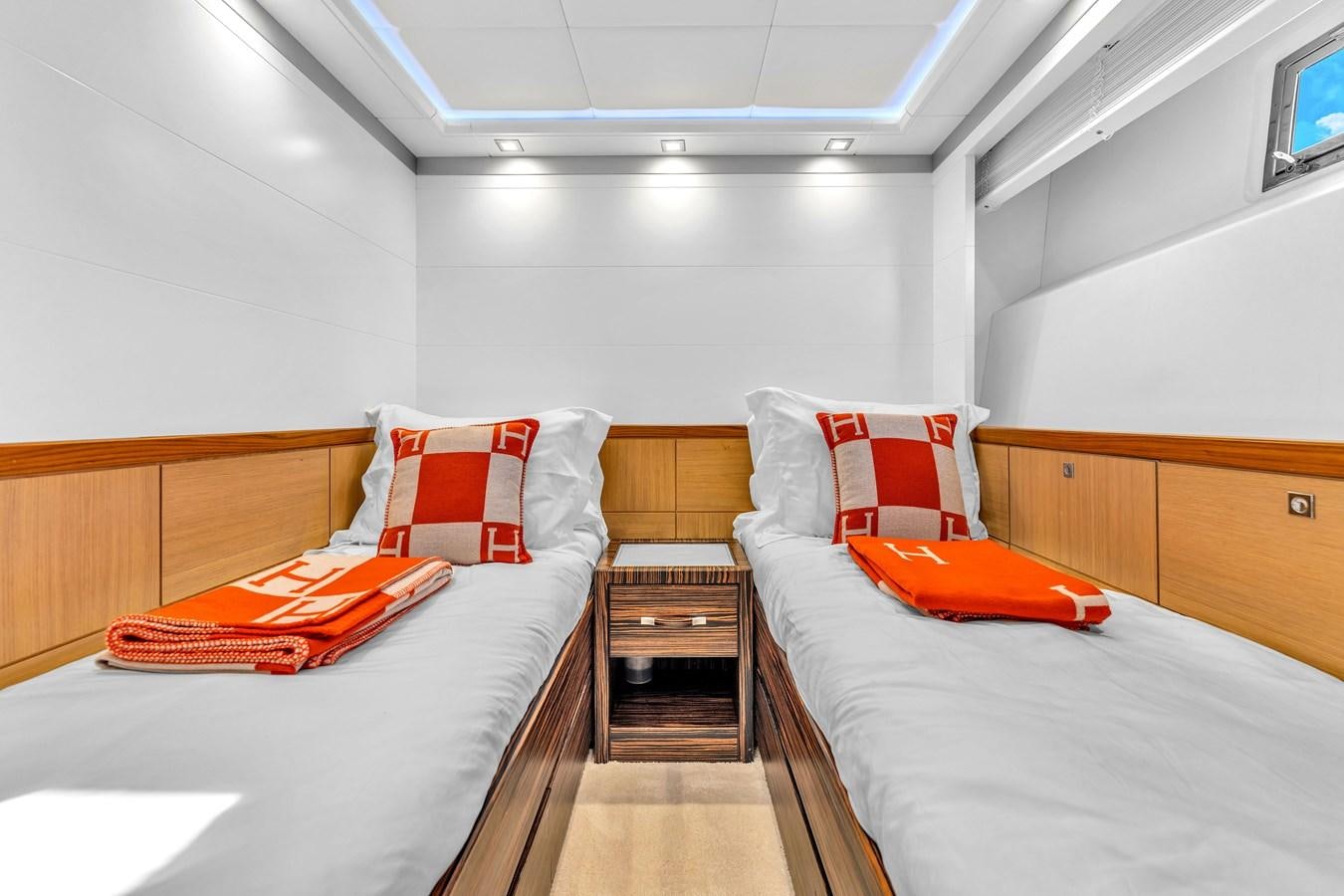 a room with beds and a dresser aboard GREYT ESCAPE Yacht for Sale