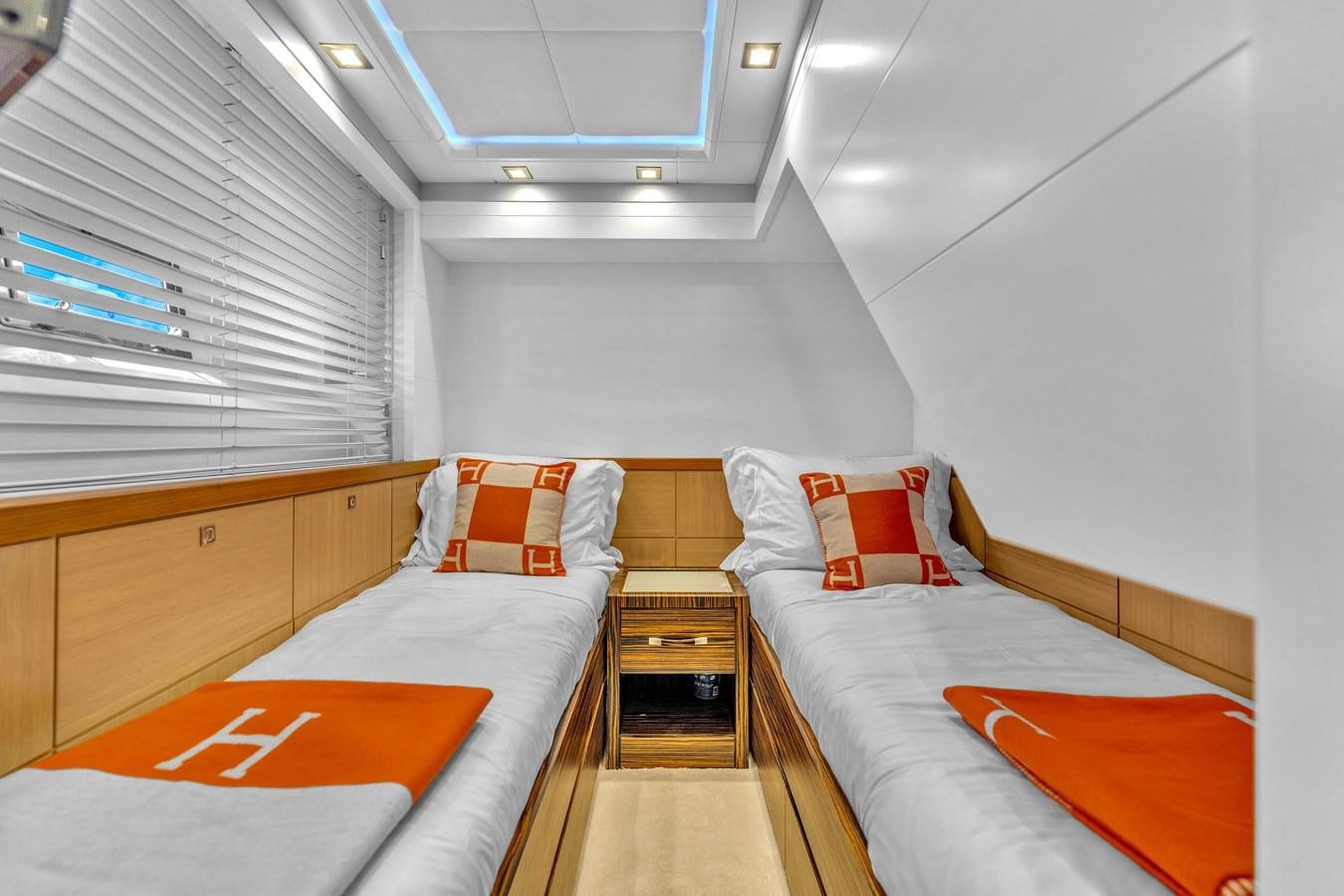 a room with beds and a table aboard GREYT ESCAPE Yacht for Sale