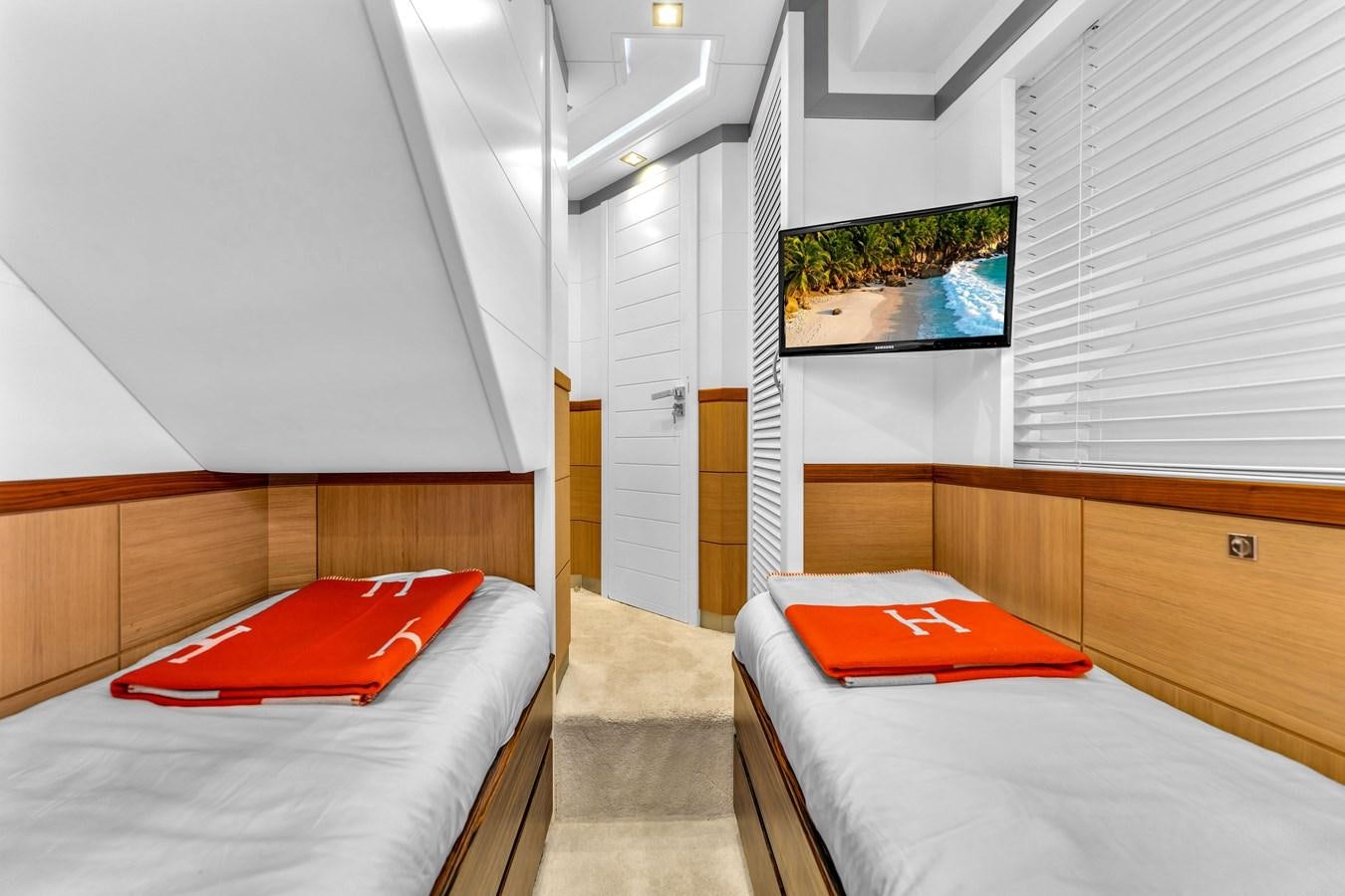 a bedroom with a red pillow aboard GREYT ESCAPE Yacht for Sale