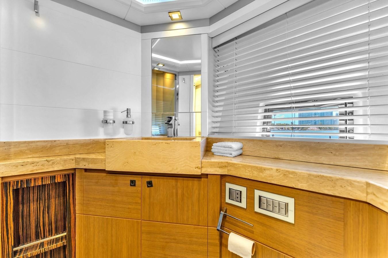 a bathroom with wooden cabinets aboard GREYT ESCAPE Yacht for Sale