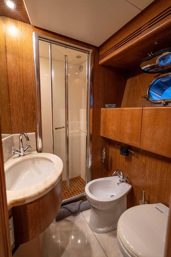 a bathroom with a shower and toilet aboard LOSAND Yacht for Sale