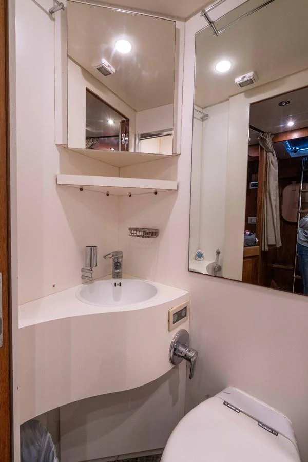 a bathroom with a sink and a toilet aboard LOSAND Yacht for Sale