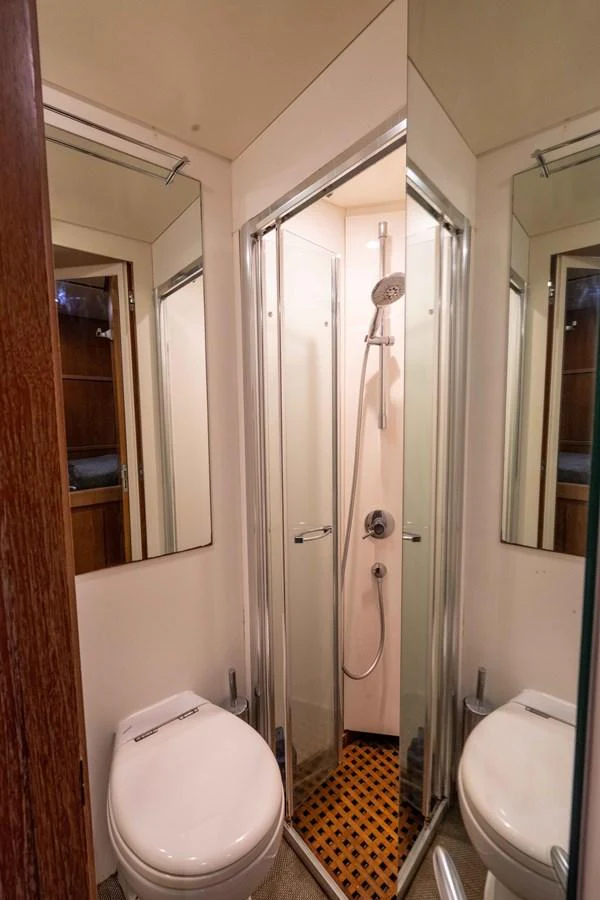 a bathroom with a glass shower aboard LOSAND Yacht for Sale