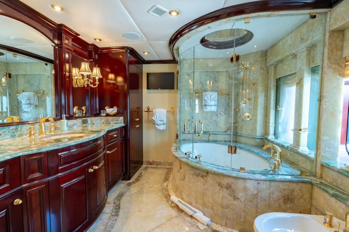 a bathroom with a large marble tub aboard MISS CHRISTINE Yacht for Sale