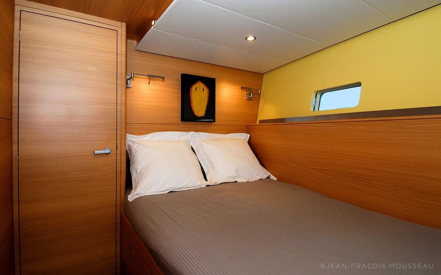 a bed with white sheets aboard WHIMSY Yacht for Sale