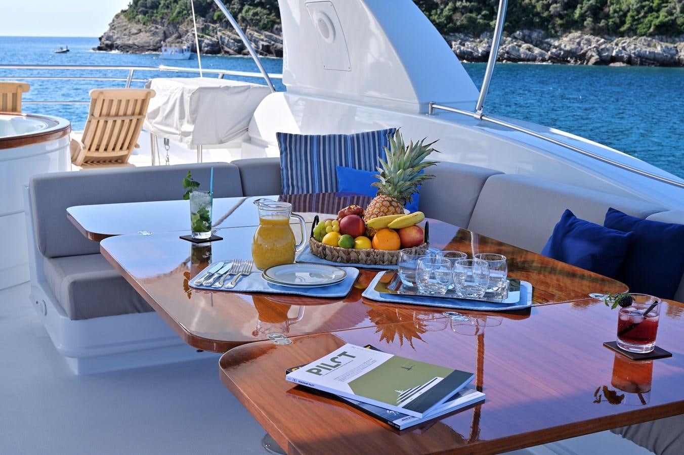 a table with food and drinks on it aboard CLARITY Yacht for Sale