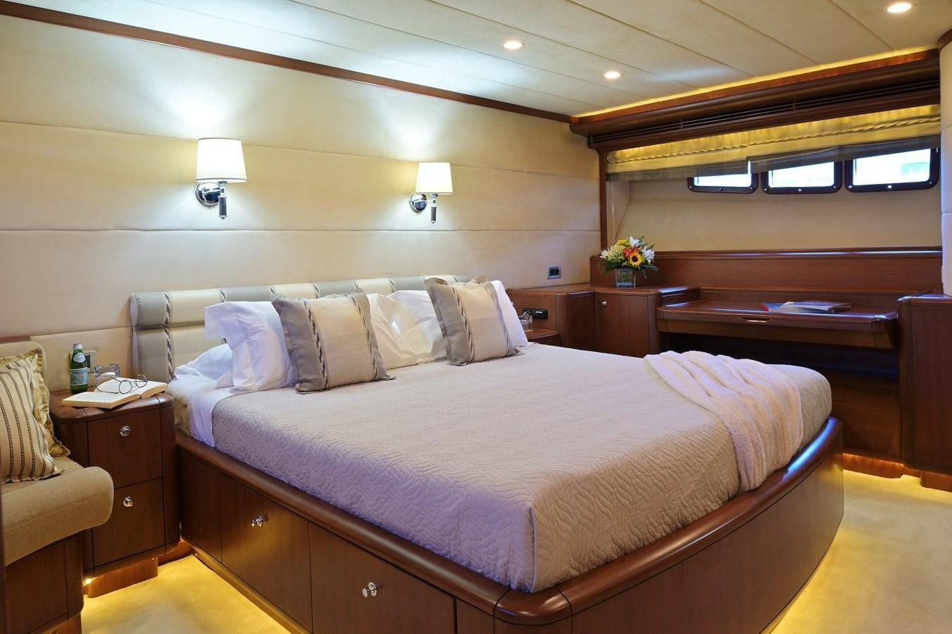 a bed with a white comforter aboard CLARITY Yacht for Sale