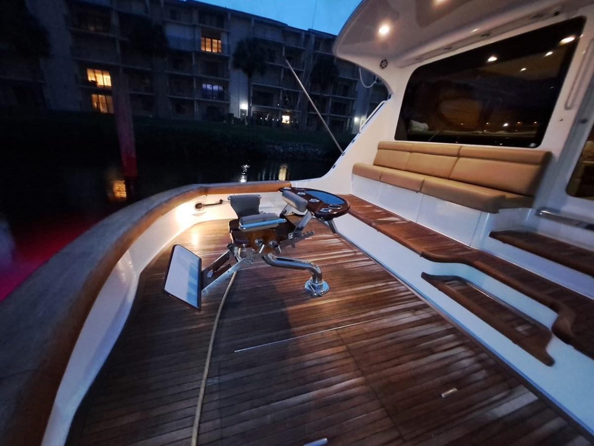 a wooden deck with a chair and a table on it aboard MARY ROSE Yacht for Sale