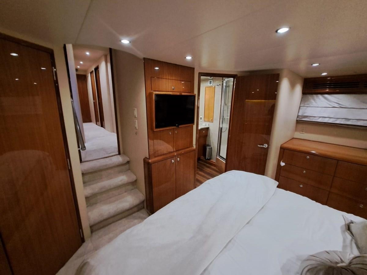 a bedroom with a bed and a television aboard MARY ROSE Yacht for Sale