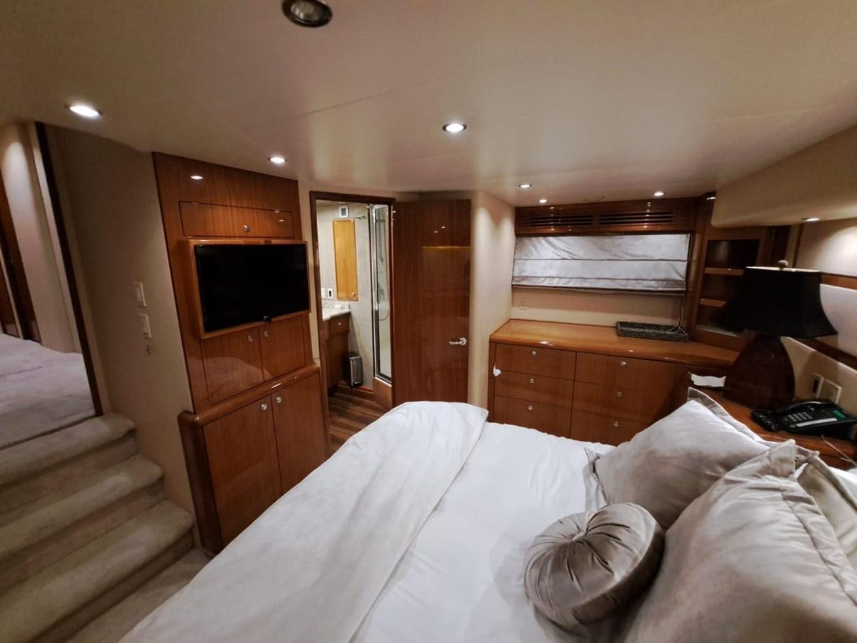 a bedroom with a bed and a television aboard MARY ROSE Yacht for Sale