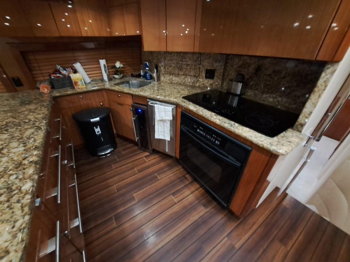 a kitchen with a black stove aboard MARY ROSE Yacht for Sale