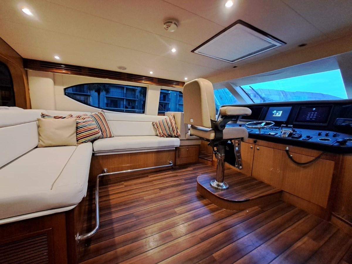 a living room with a large television and a table aboard MARY ROSE Yacht for Sale