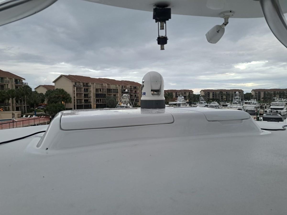 a snow covered rooftop with a white statue and buildings in the background aboard MARY ROSE Yacht for Sale