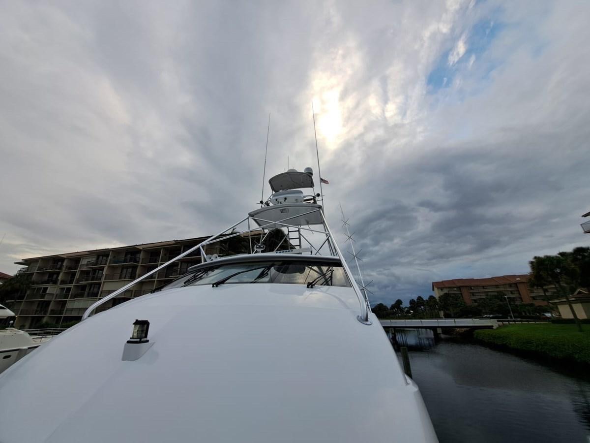 a large white boat with a rainbow in the background aboard MARY ROSE Yacht for Sale