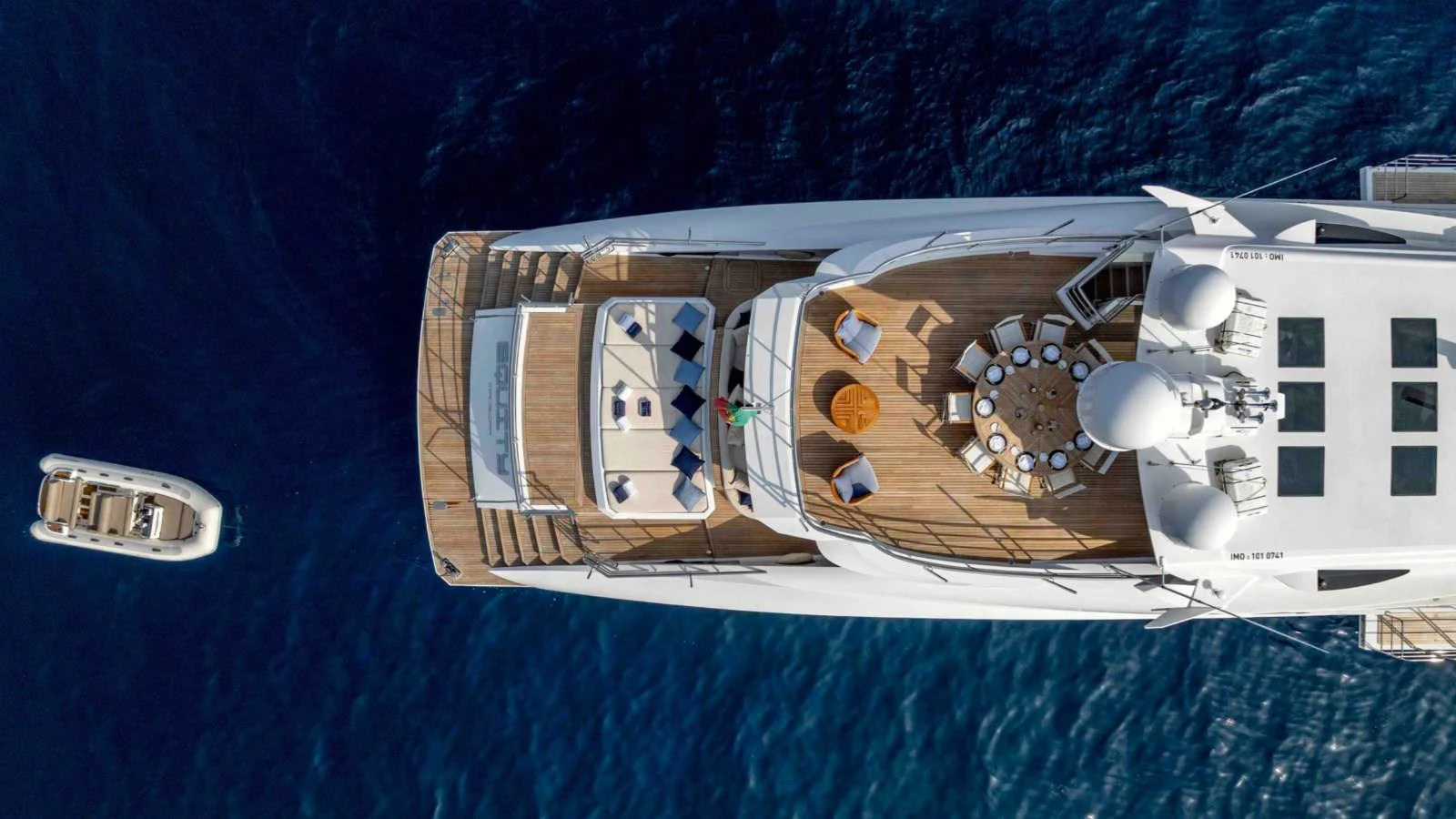 A stunning aerial view of the yacht's sundeck, showcasing luxurious lounging and dining areas. aboard PALMER JOHNSON 150 Yacht for Sale