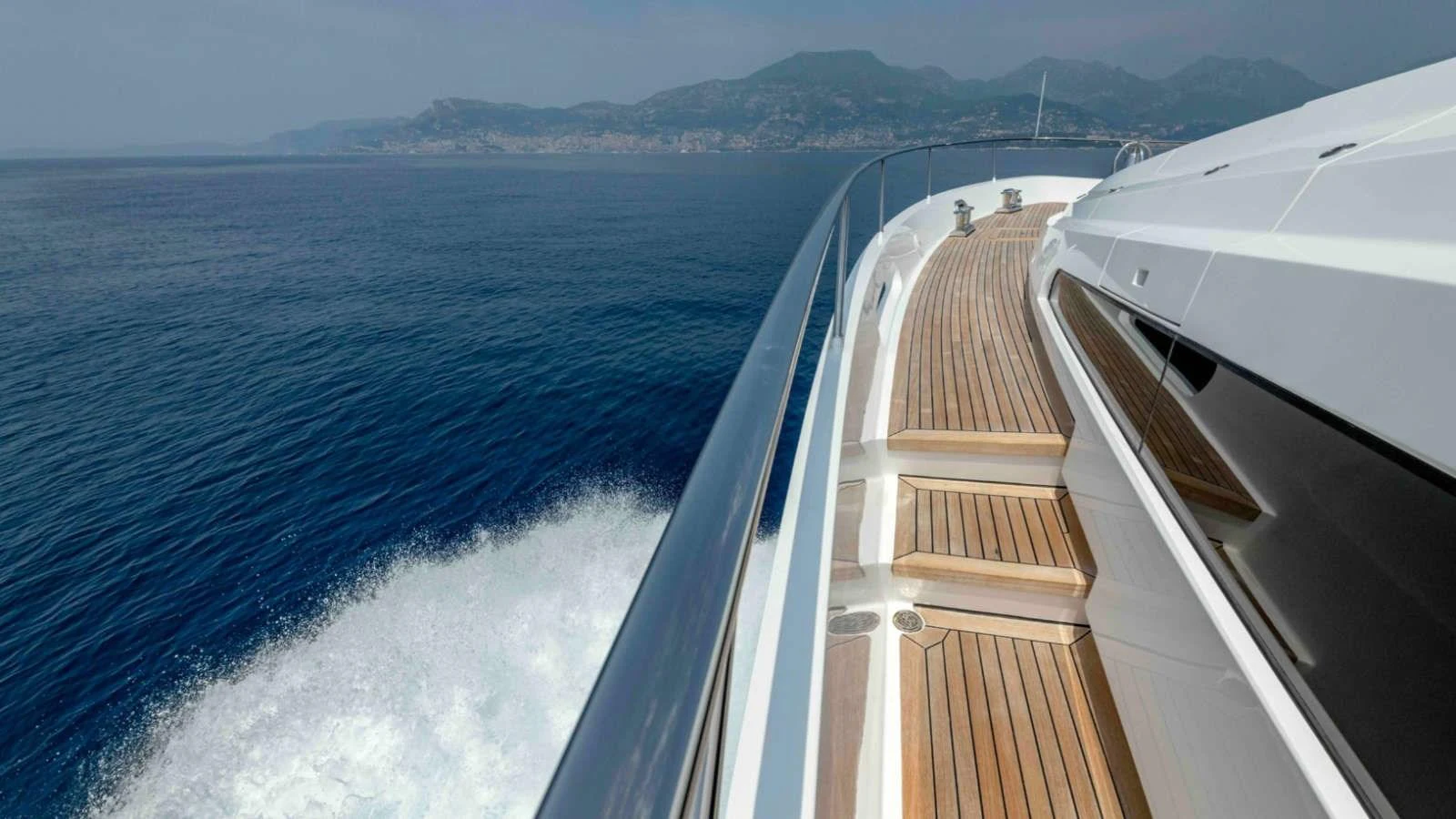 The yacht cruises smoothly through the water, showcasing its sleek deck and stunning ocean views. aboard PALMER JOHNSON 150 Yacht for Sale