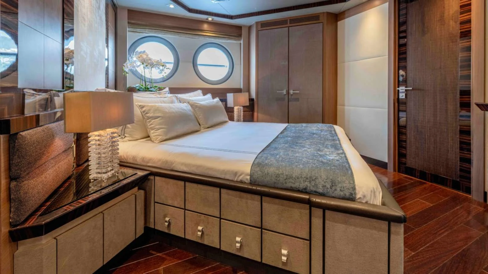 The master stateroom features a luxurious bed with elegant decor and ample natural light. aboard PALMER JOHNSON 150 Yacht for Sale