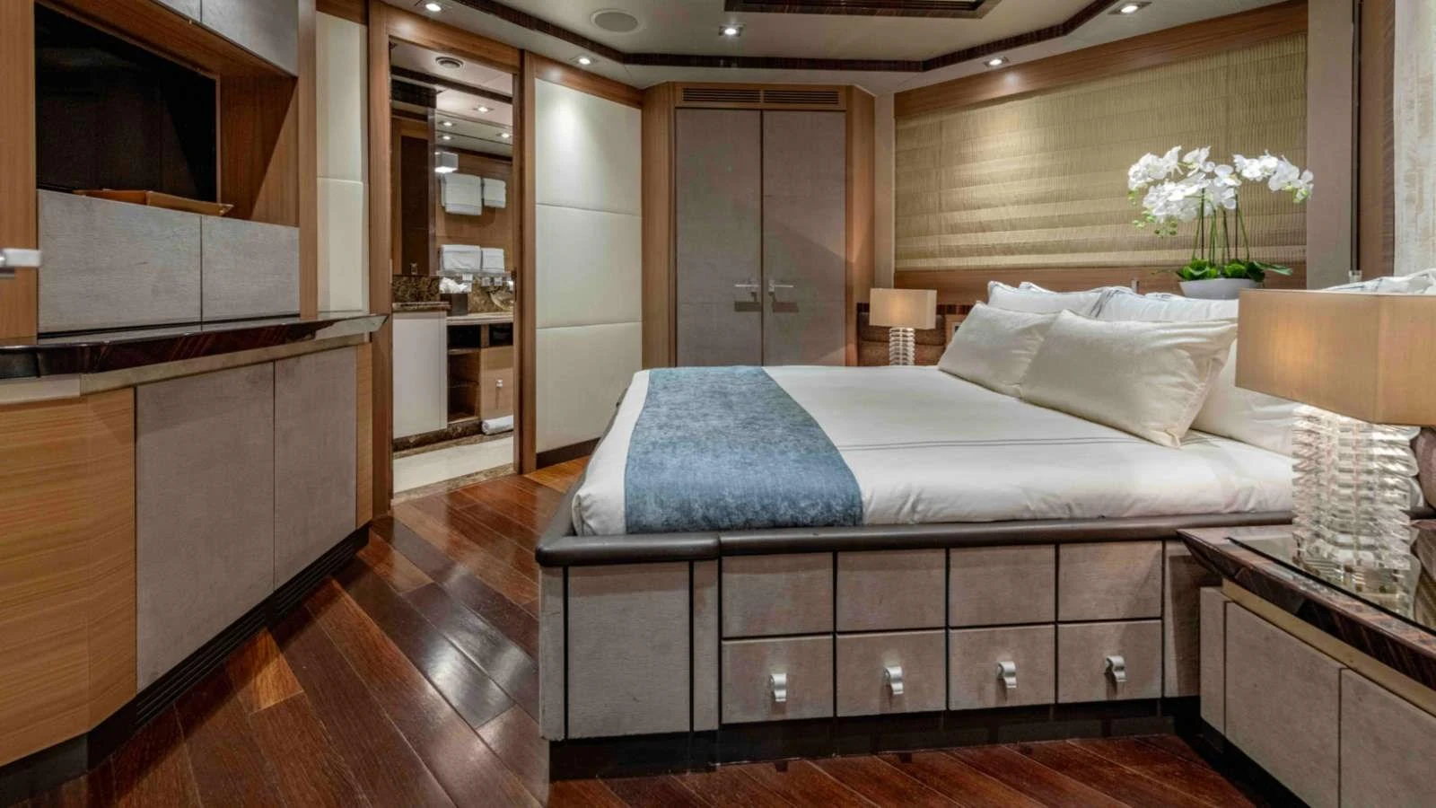 The master stateroom features a spacious bed, elegant decor, and ample storage. aboard PALMER JOHNSON 150 Yacht for Sale